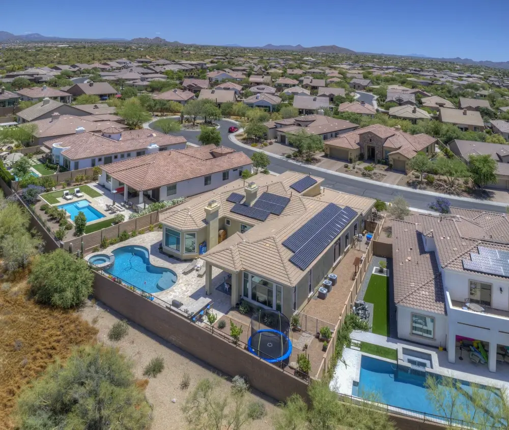 Solar panels on a house with a pool and trampoline in Phoenix, AZ 85032